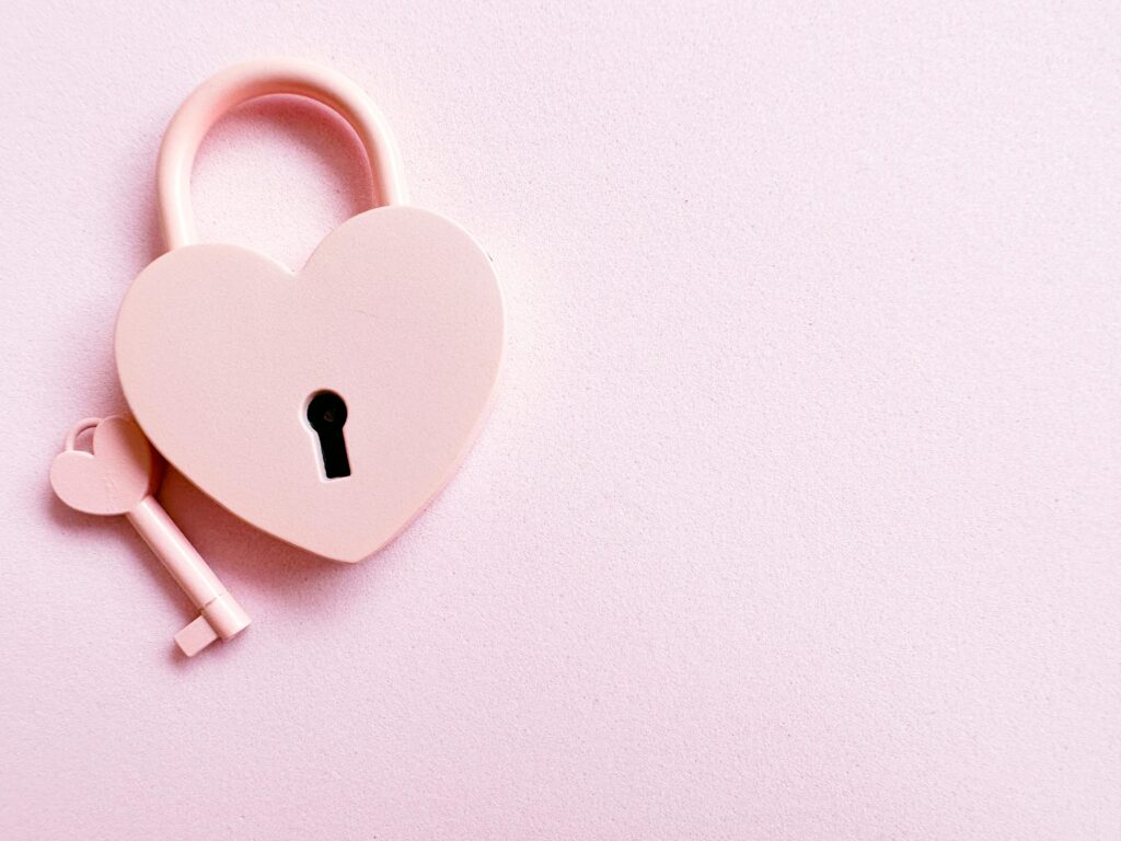 pexels-photo-15490921-15490921 Aesthetic photo of a heart-shaped pink padlock with a matching key on a pink background, perfect for love themes.